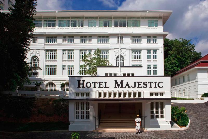 White colonial facade of the original Hotel Majestic building with its porte-cochère